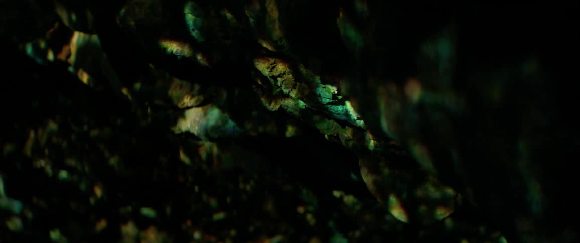 Lights are projected onto a cave wall