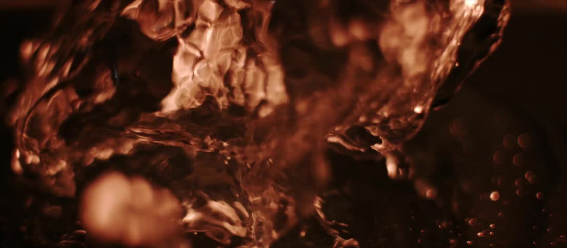 Backlit red liquid bubbling inside a container
