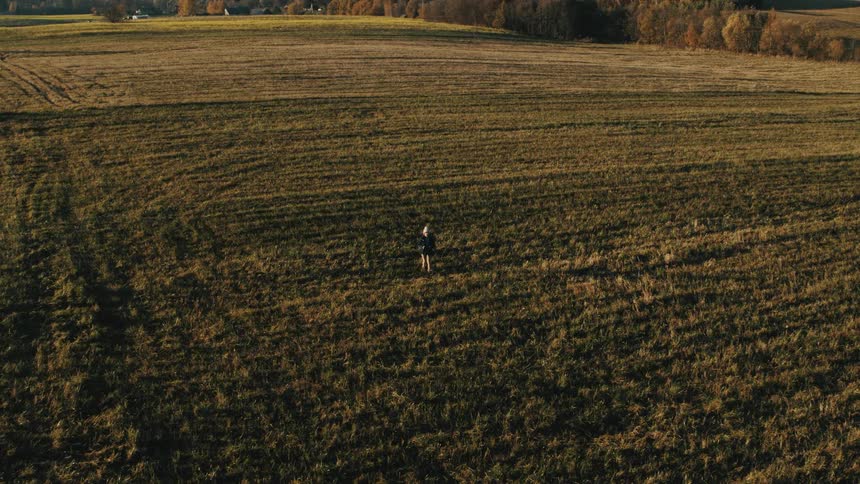 A person is hiking on the green field
