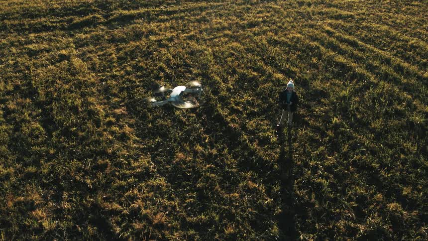 A person flying a drone in an open field