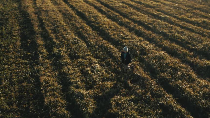 A person flying a drone in a field