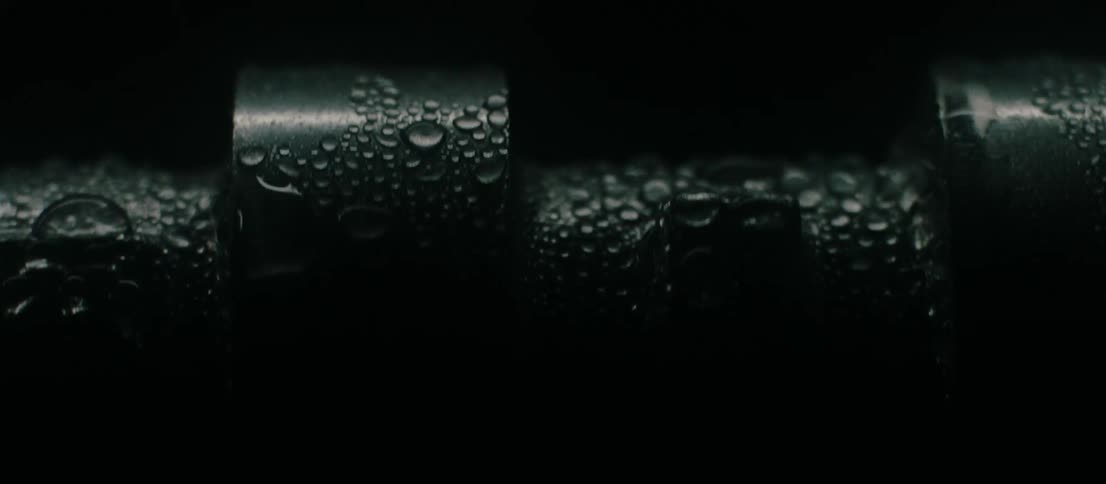 Water spraying over a rotating metal cylinder