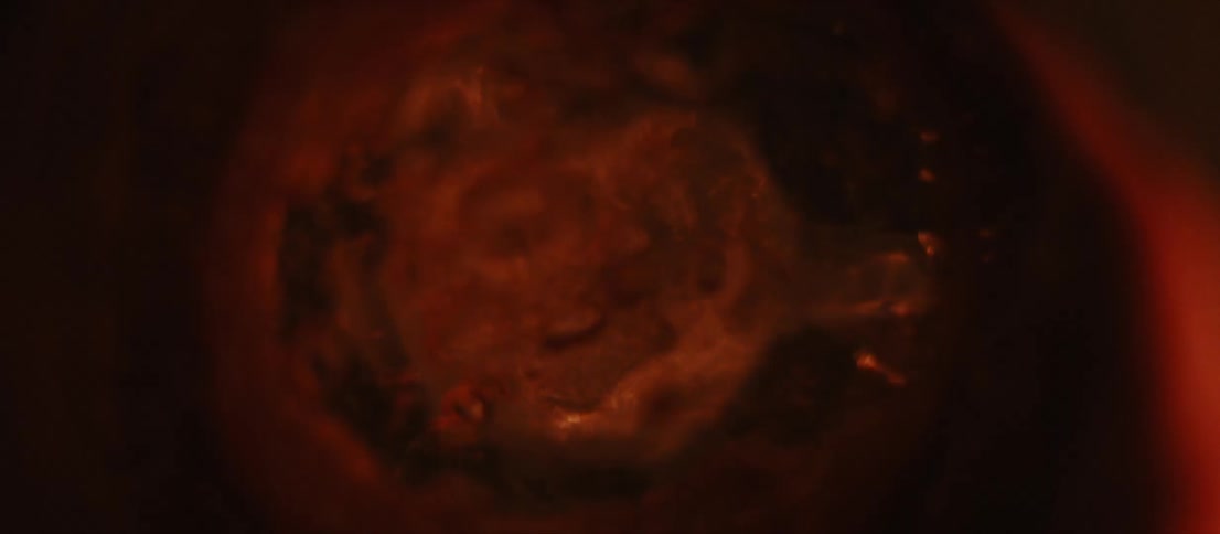 Red and orange colored liquid bubbles and roils