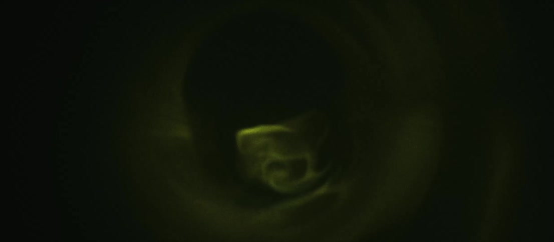 Green black and yellow colors that look like smoke and light
