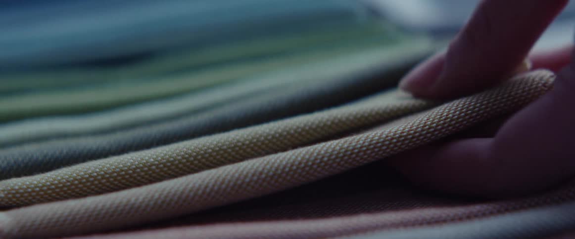A person feeling different fabric samples