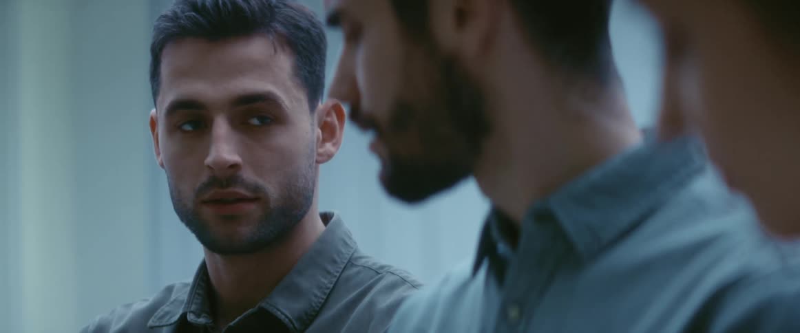Two men standing next to one another having a conversation