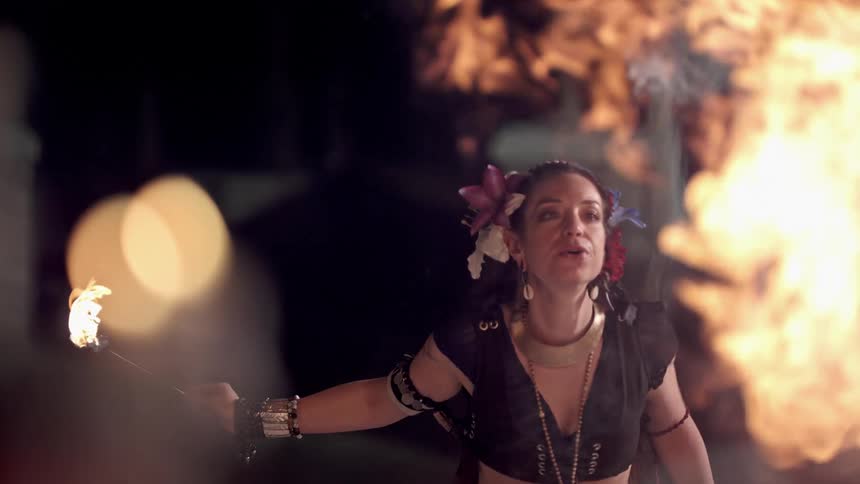 A woman performing blows fire