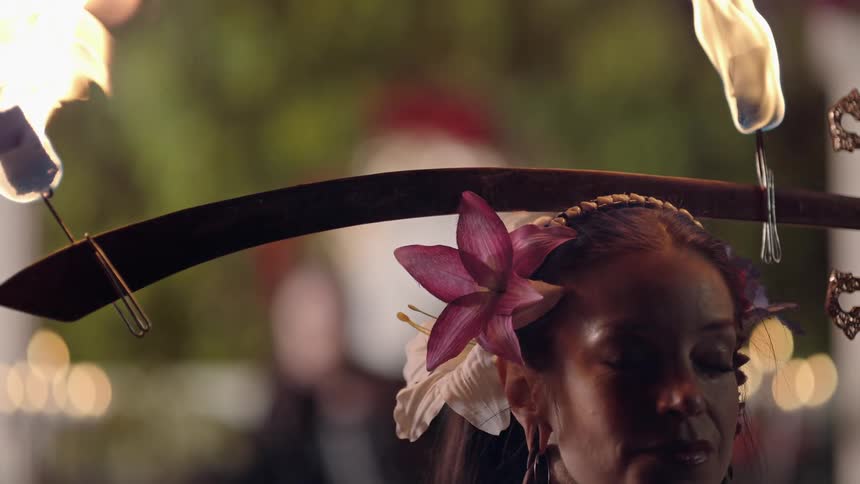 A woman dancing with fire on her head
