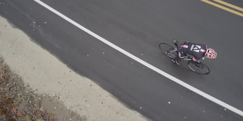 A person rides a bike onto a road