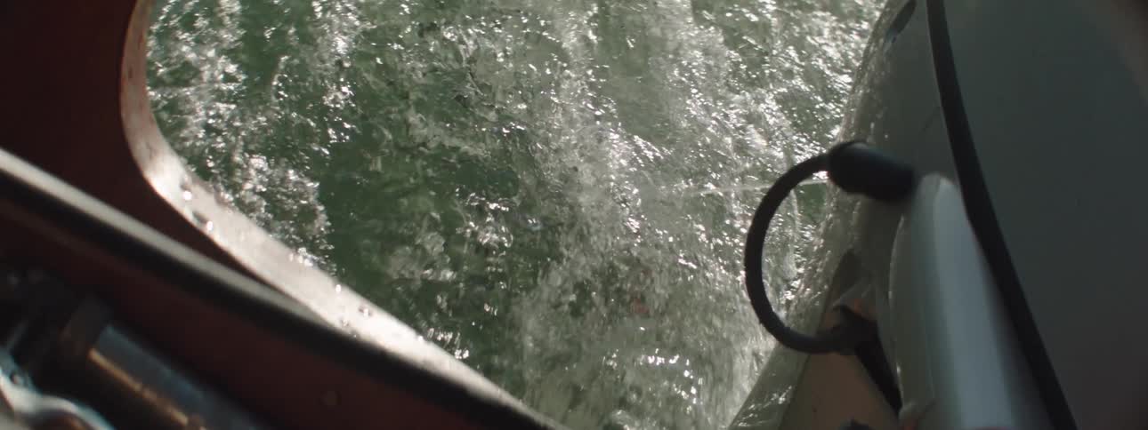 An up close view of a boat engine in the water