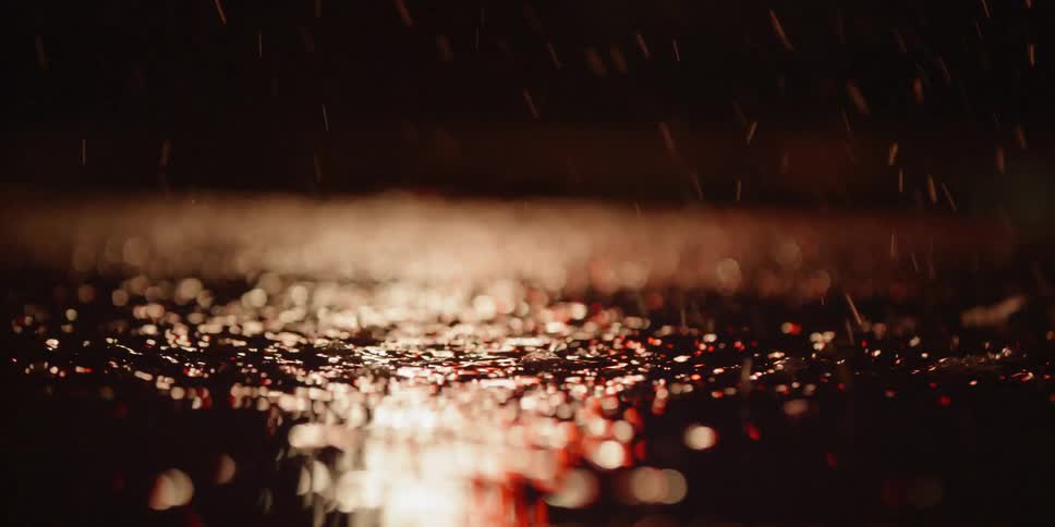 Water splashes as a bicycles goes through a puddle