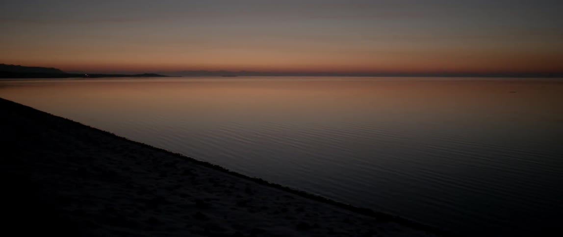 The water is calm as the sun sets