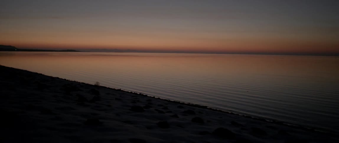 The sun is setting on this shore