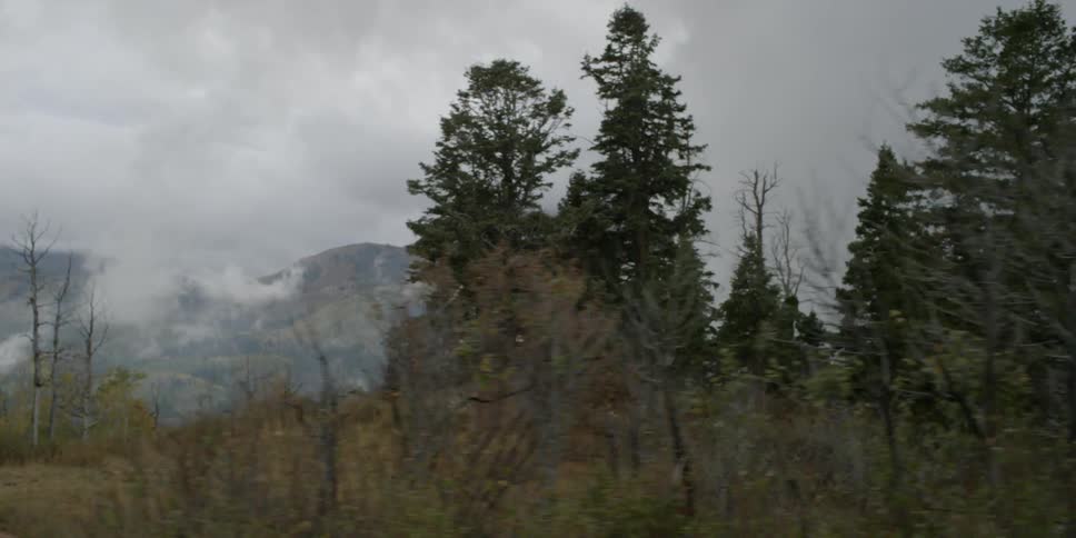 Passing view of mountains covered with heavy clouds