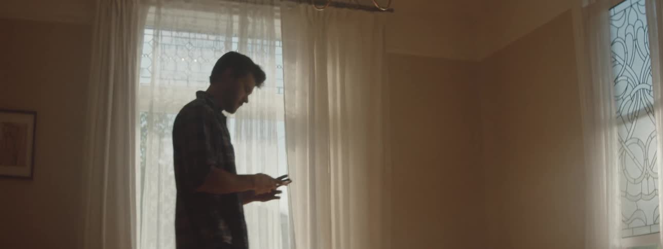 A man is walking around an empty room
