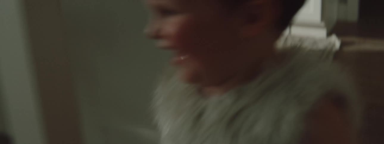 A child is running around in the kitchen