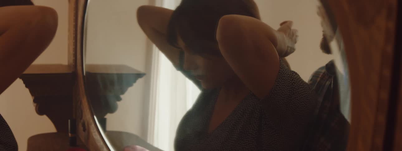 Young couple standing in front of a mirror in a room at home