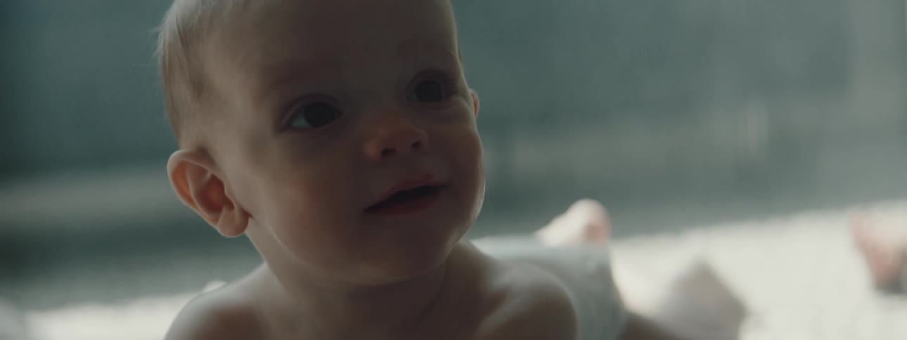 A baby laying on a rug