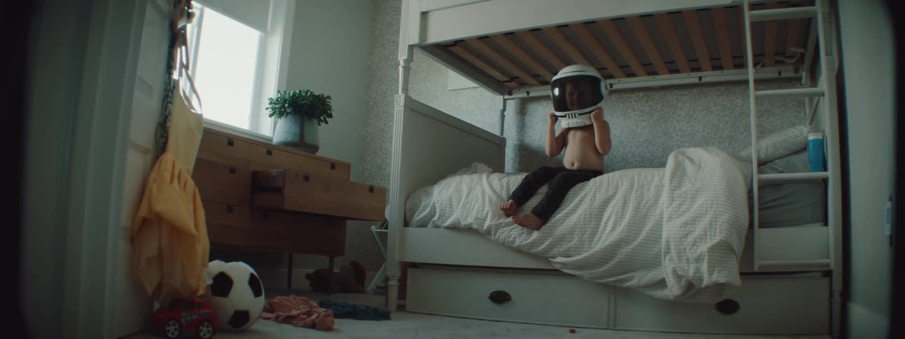 A child puts on an astronaut helmet