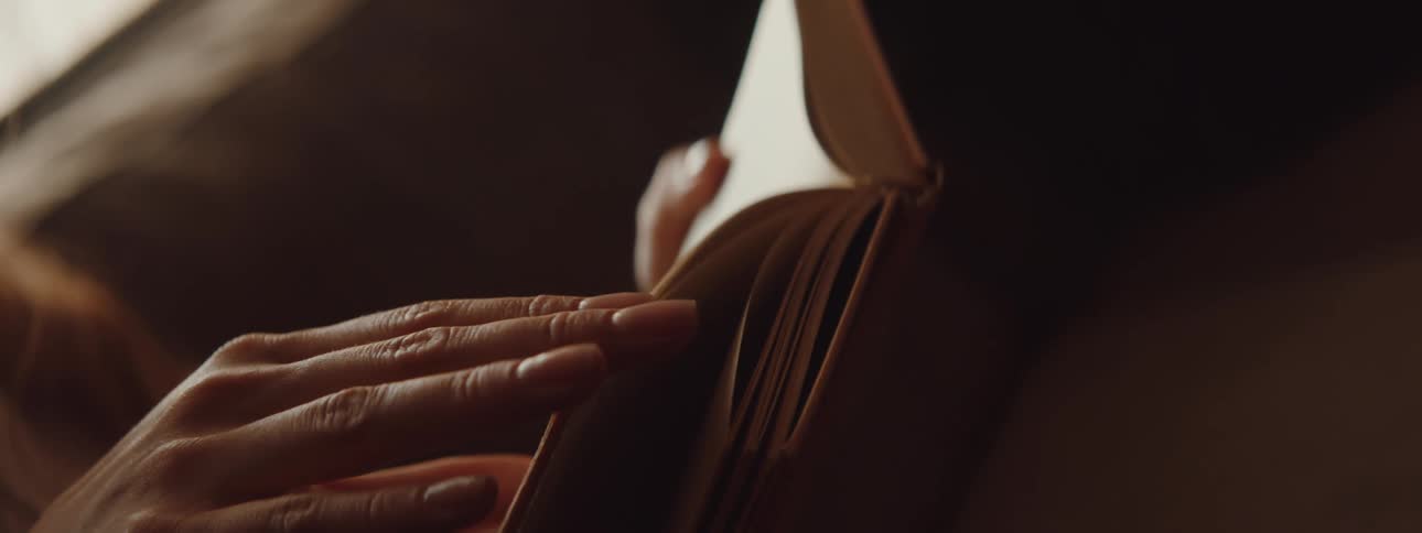 Woman turns the pages of a book