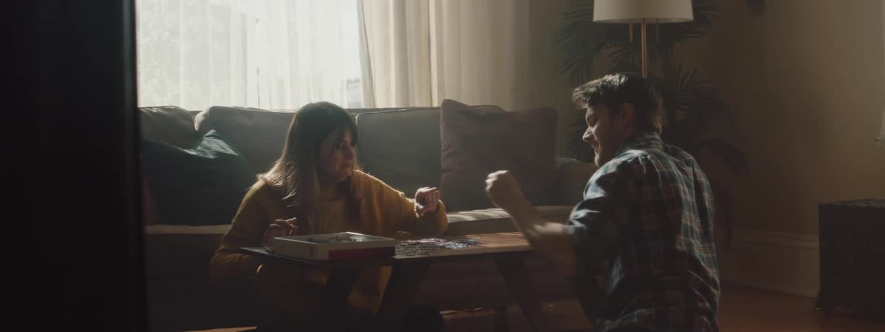 Husband and wife are playing a game indoors together