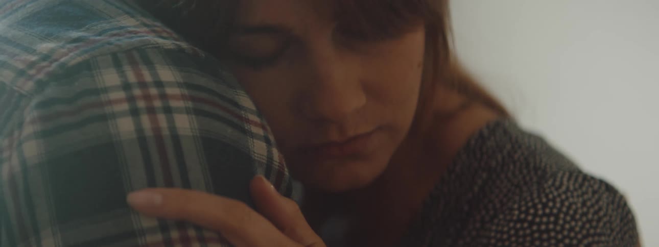 A couple hug in their home