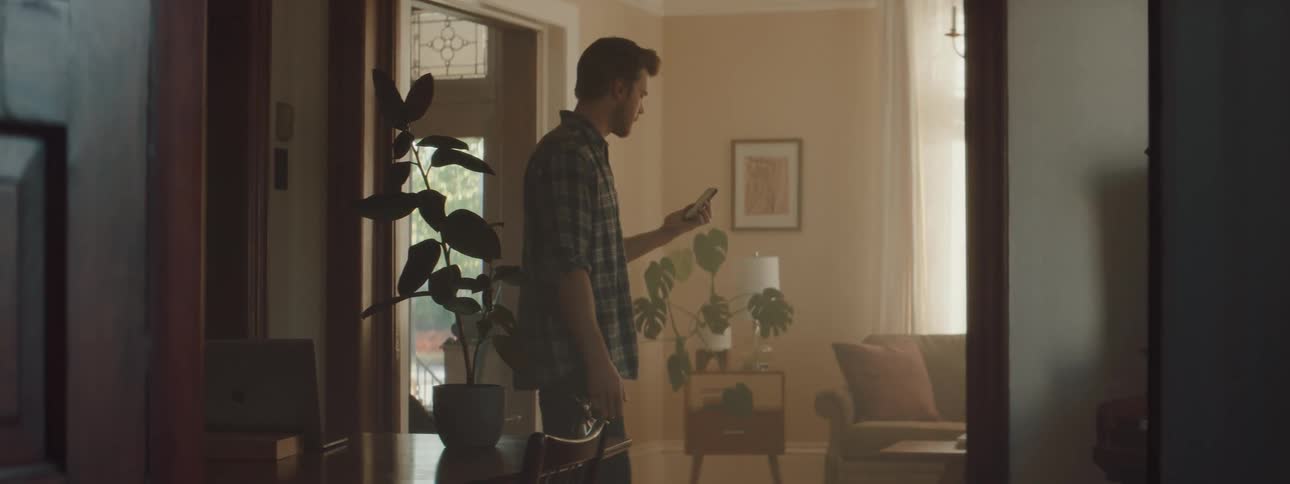 A man walking around talking on a smartphone