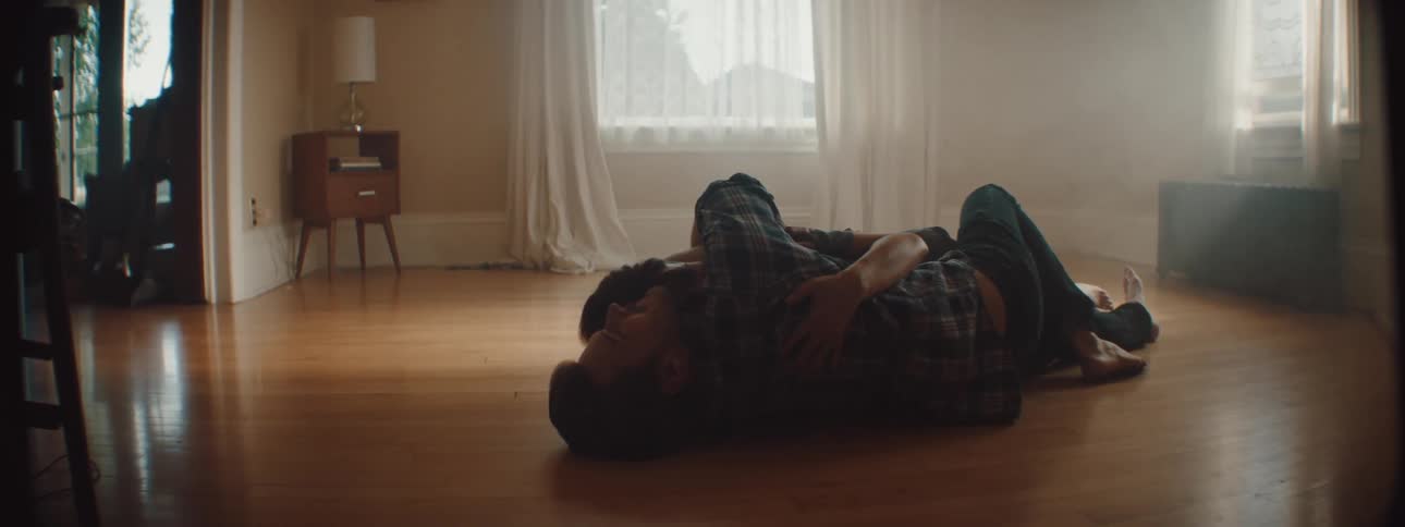 A man and woman cuddling on the ground