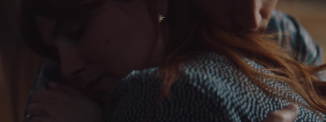 Two people hugging each other