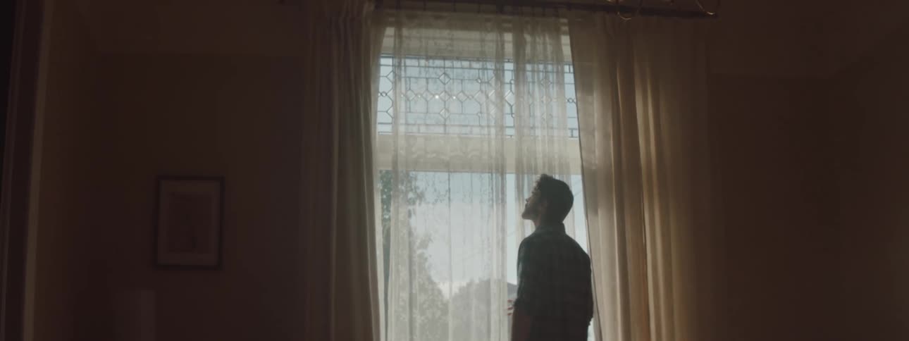 A man staring out of a window