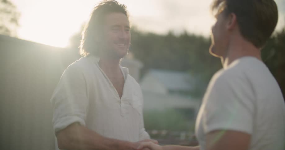 Two men shaking hands outdoors
