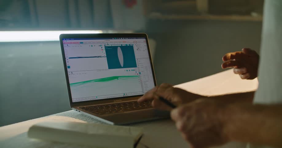 A 3D surfboard model is shown on a computer screen