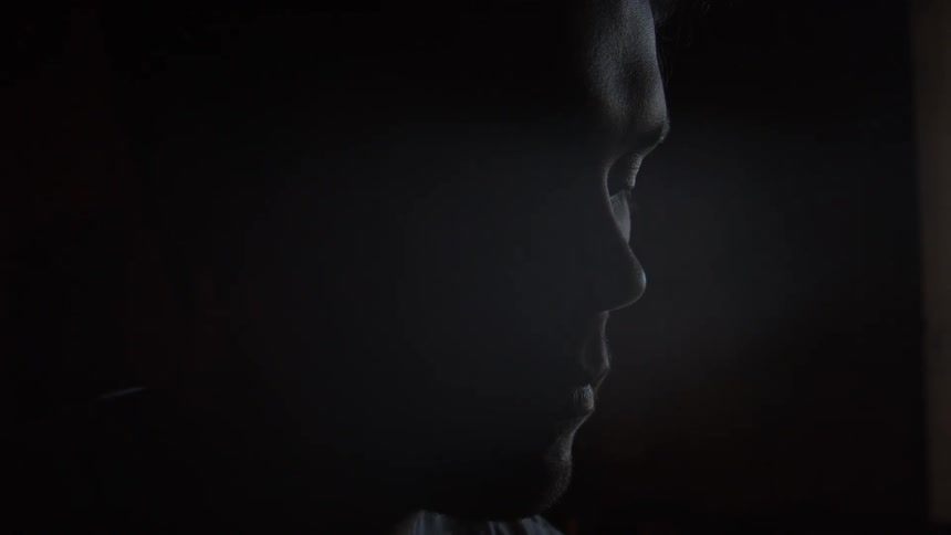 Silhouette of a mans face inside a dark room