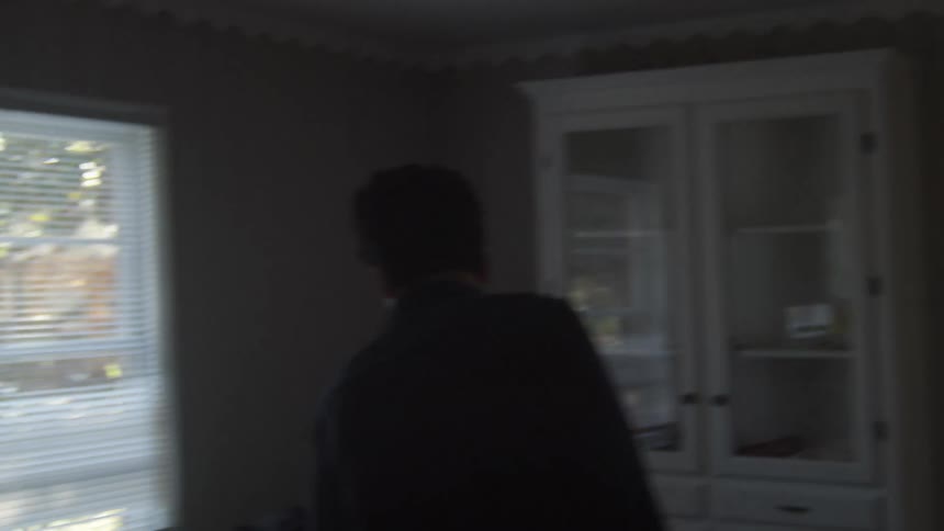 A man walking through a house