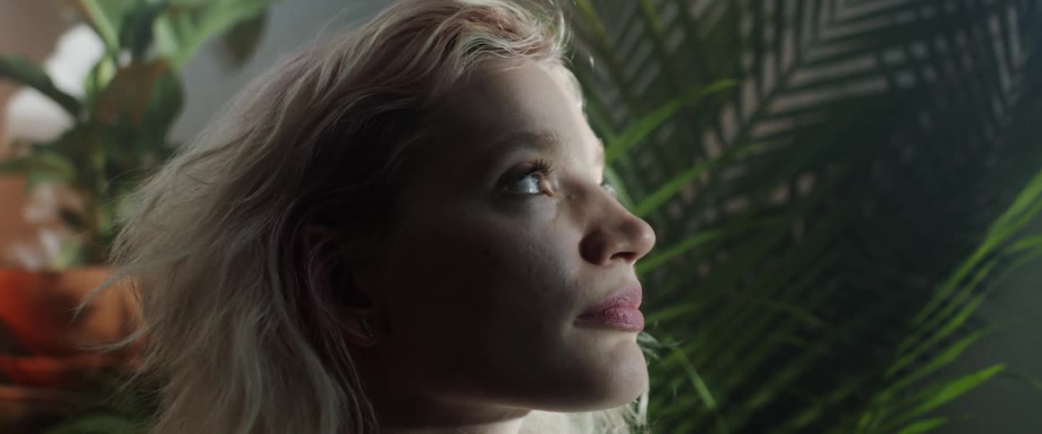 A young woman at home looks in to the distance