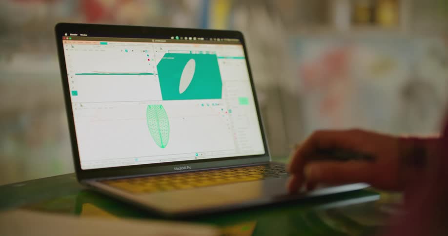 A young woman designing a surfboard in a 3D program