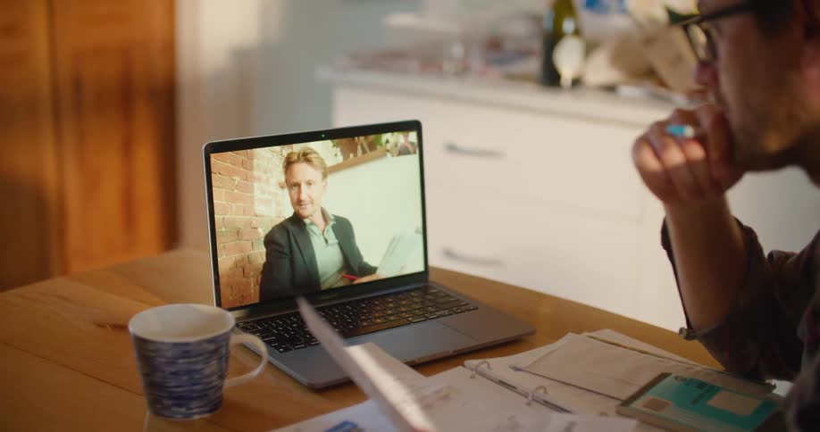 Two people talking on a laptop
