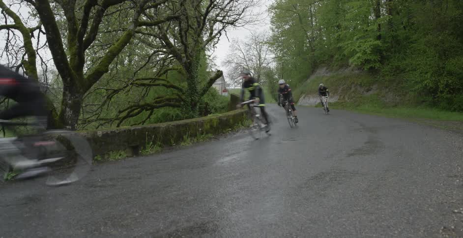 People race down a road on bikes