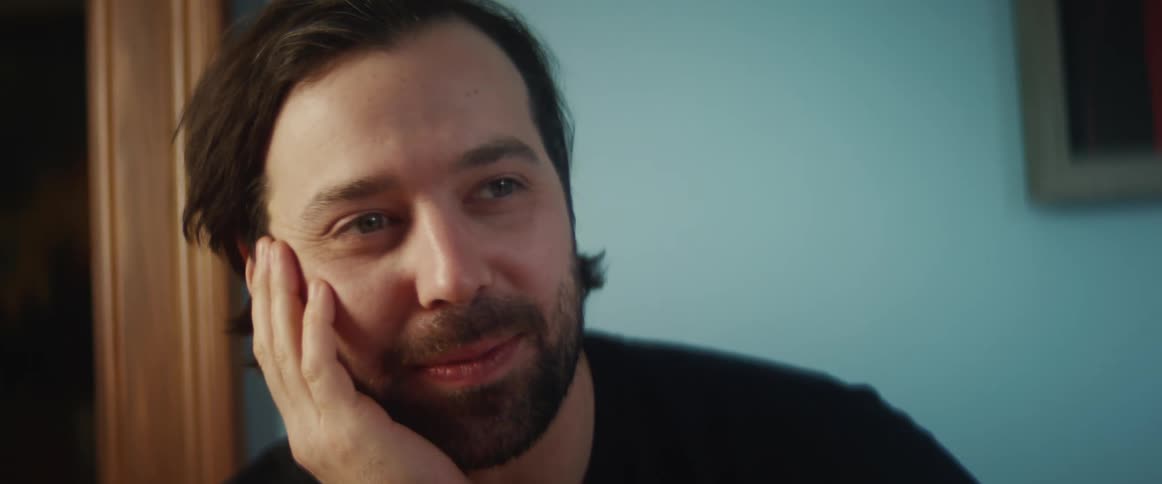 A man with a beard smiles