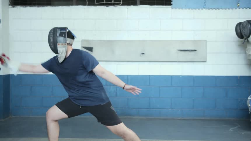 A man is standing in a room and doing sports