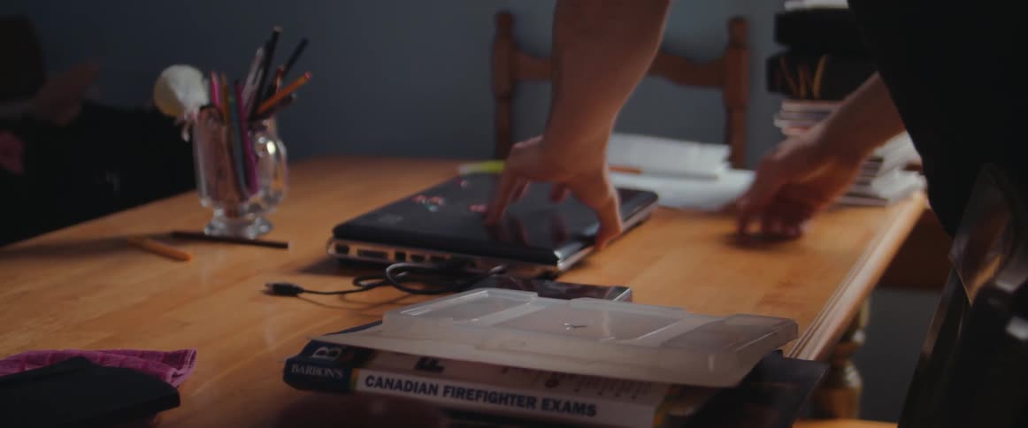 A man plugs in his laptop