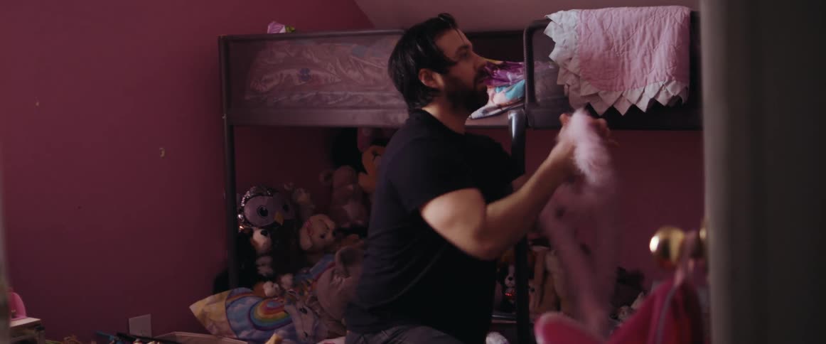 Father picking up dirty clothes for laundry from his daughter room