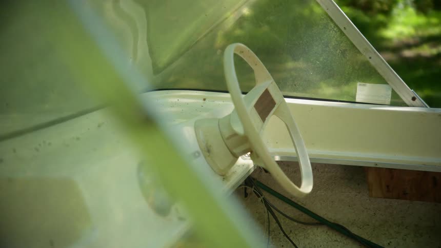 A view of a boat sitting in a field