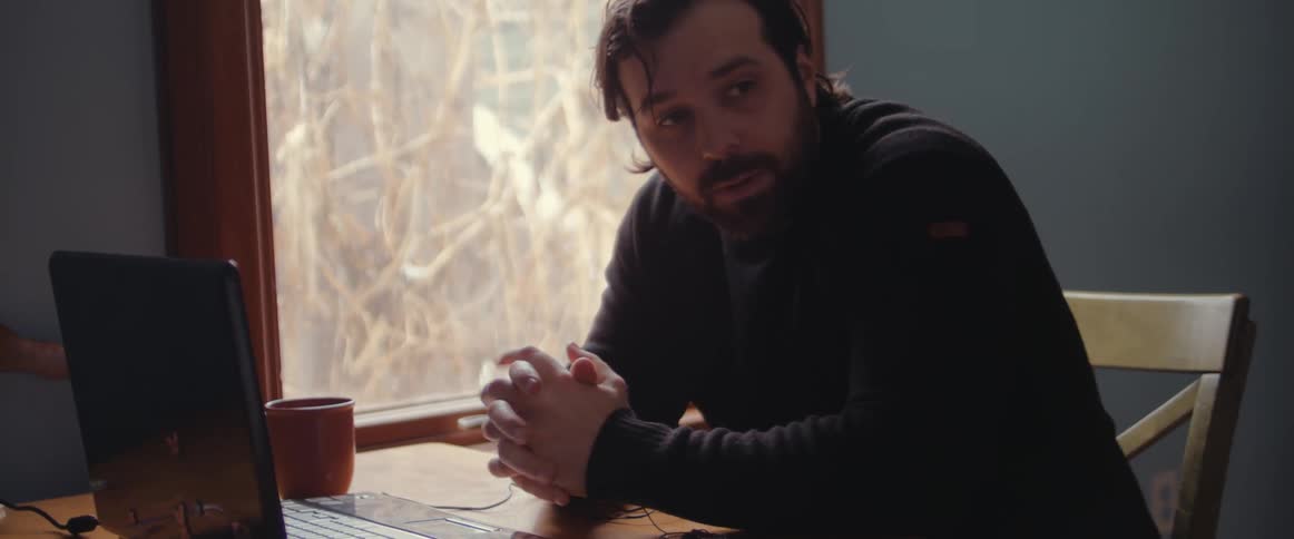 Man has a nervous breakdown while sitting in front of a laptop at home