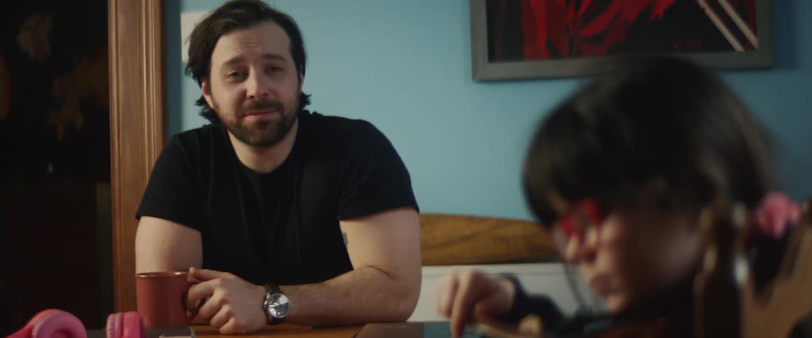 A man watching a child play a violin