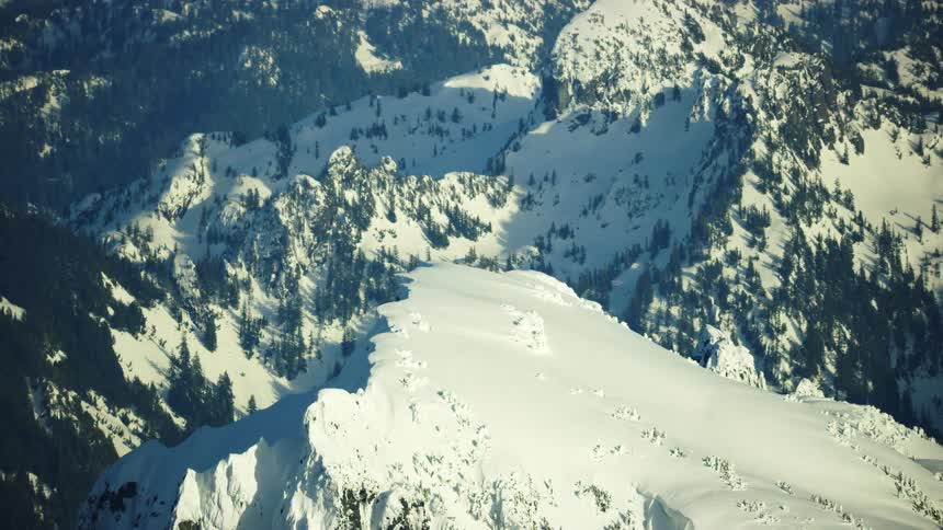 Heavy snow clings to the dramatic and steep mountains of the High Cascades in Washington State