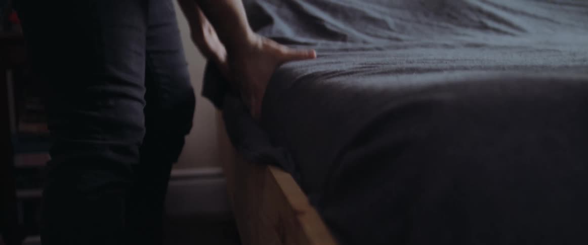 A man that is putting a bed back together