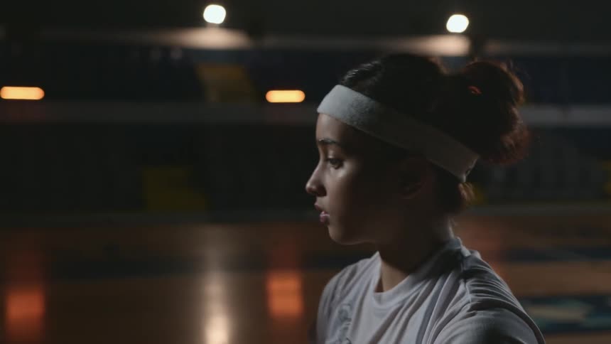 Woman practicing basketball shot