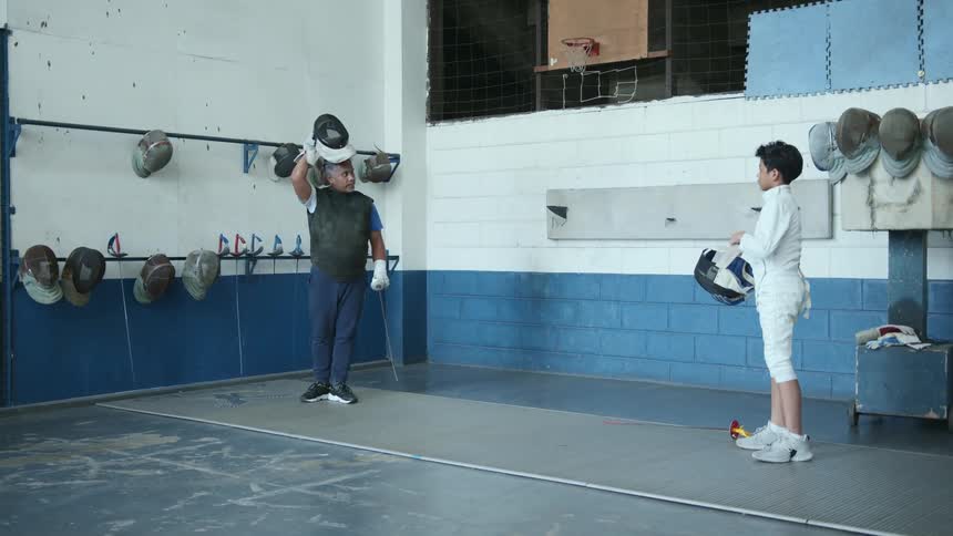 Two people getting ready to practice fencing