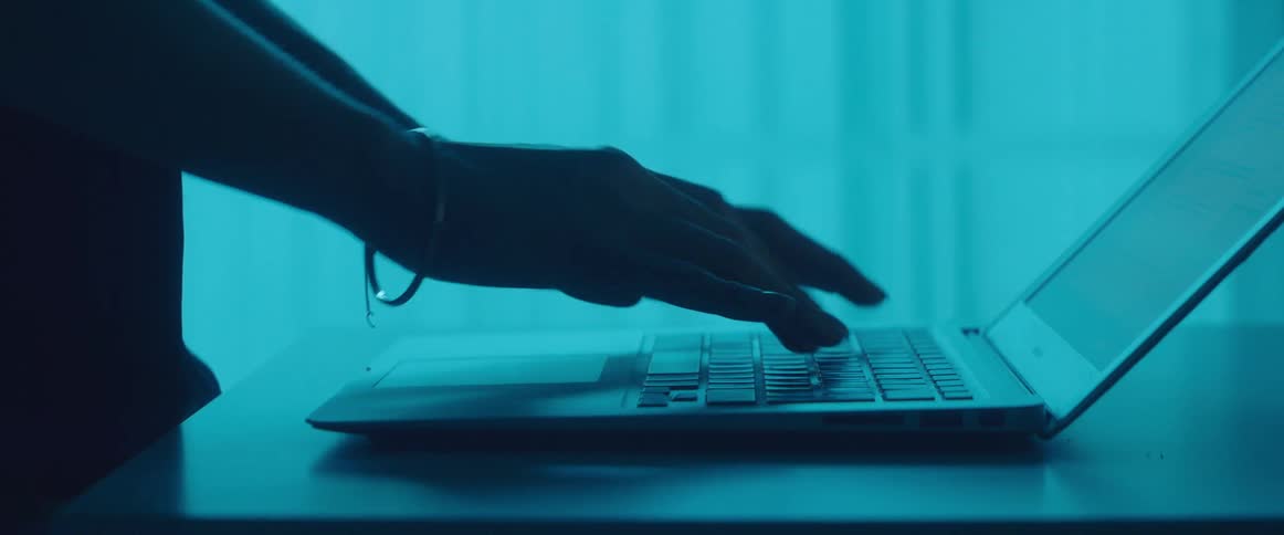 A person is typing on the laptop